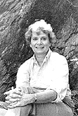 Barbara McMartin sitting at the base of a large tree