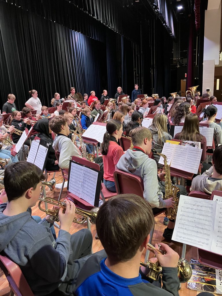 Orchestral students practicing on the auditorium stage