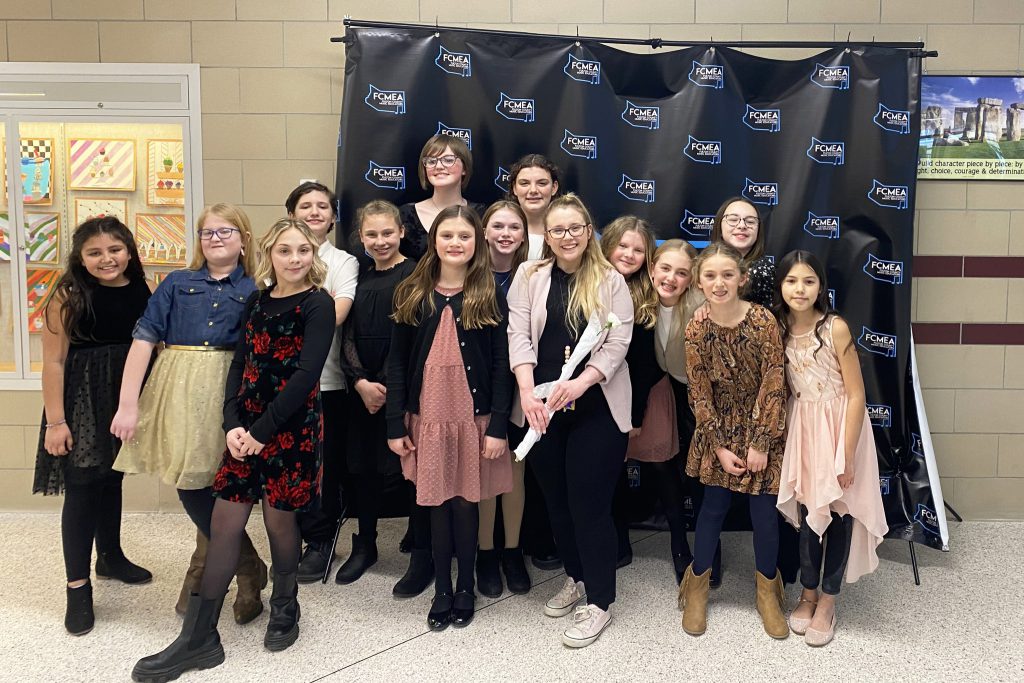 Several students pose together in a hallway