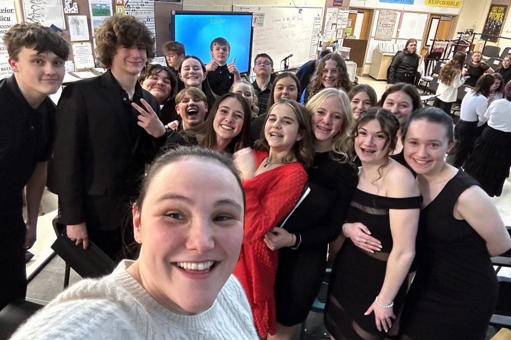 A teacher takes a selfie with 17 students of middle to high school age