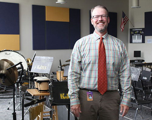 Andy LaCoppola in an empty music classroom