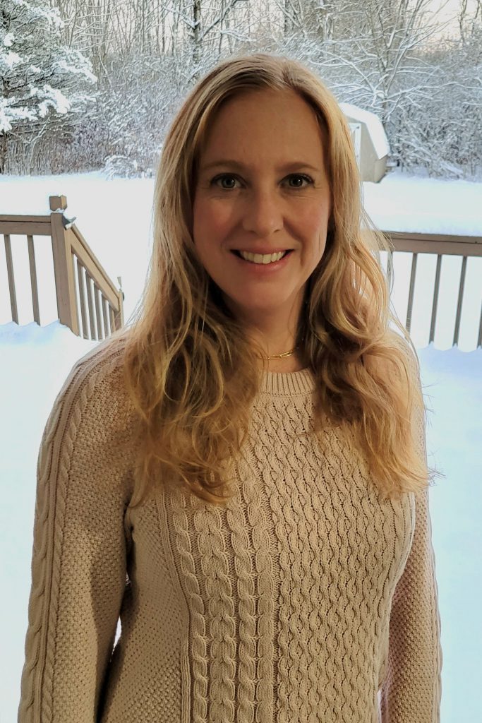 Katie Warner stands in front of a snowy window