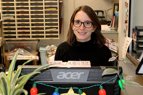 Kay Houtz sits behind a computer monitor at her desk in the main office