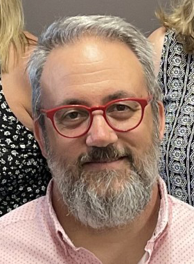 Board president David D’Amore headshot with red glasses