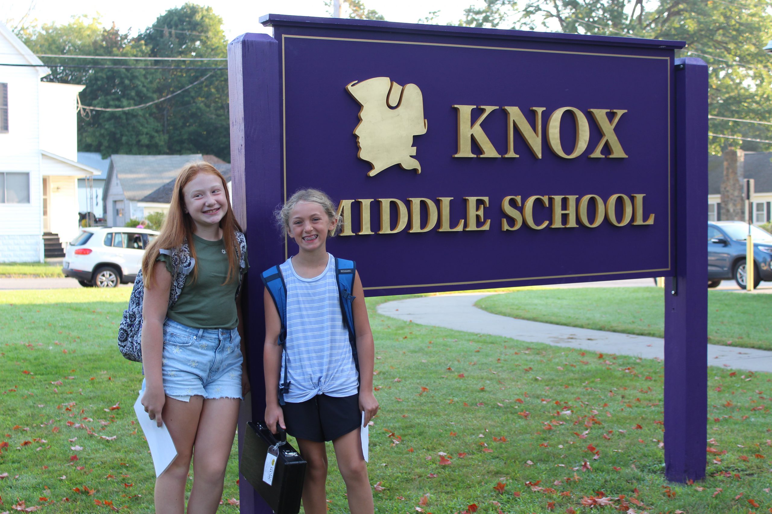 Two students pose happily with the Knox Middle School sign