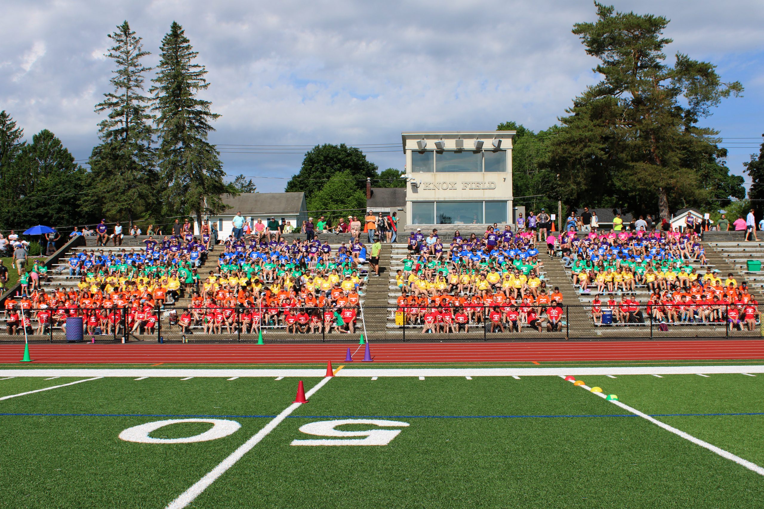 Crowd in the bleacher display rainbow tshirts