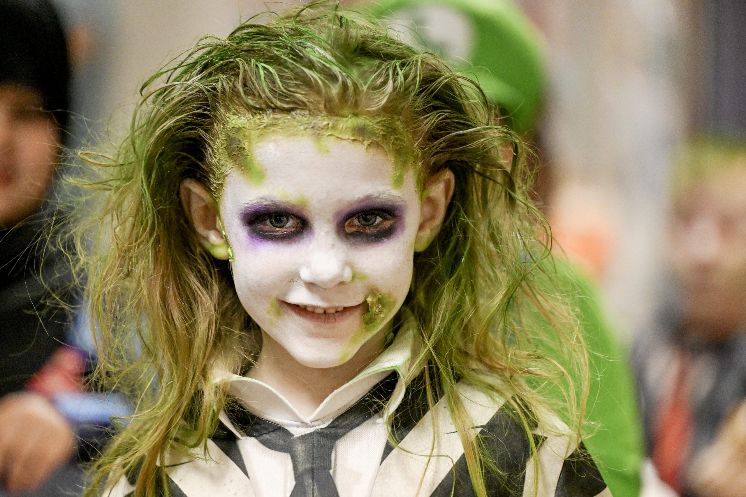 a young child dresses up as Beetlejuice for Halloween