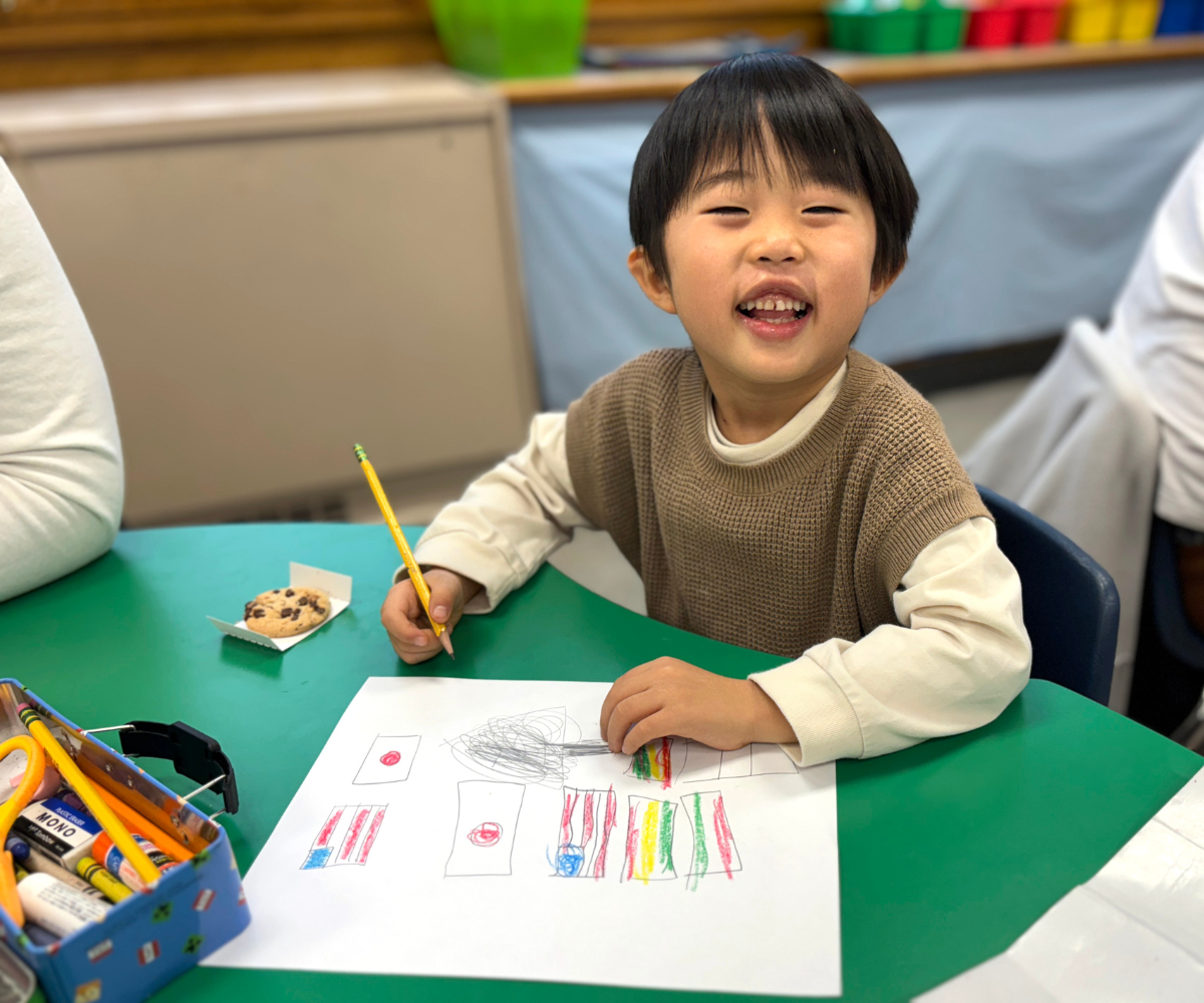 a young boy draws pictures