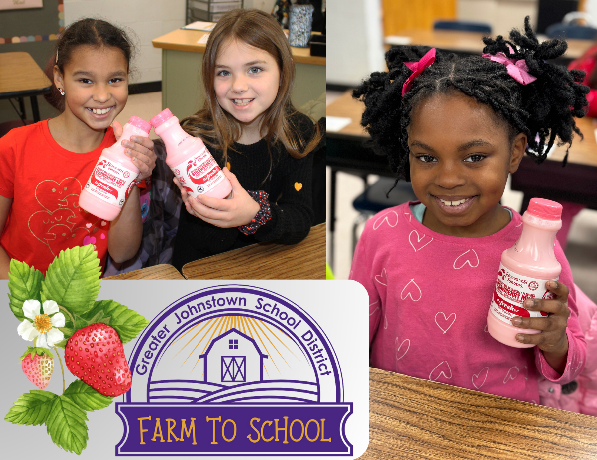 three young girls hold up bottles of strawberry milk